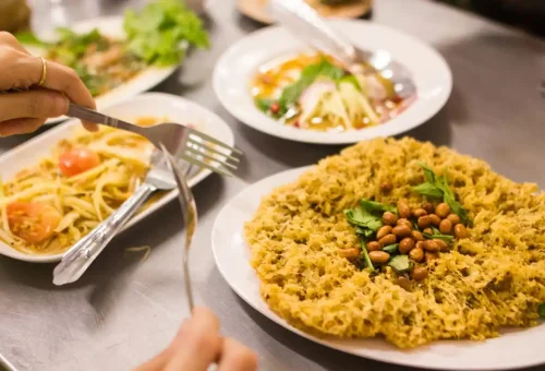 Guest enjoying papaya salad at Yaowarat Road during Bangkok Midnight Food Tour by Tuk Tuk with Phuket Travel Store