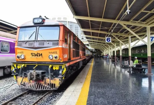 Orange Thai train at Bangkok railway station platform