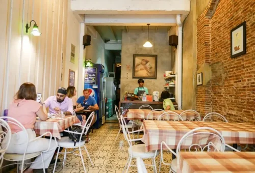 Cozy Bangkok café interior with locals dining at tables
