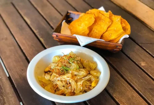 Pomelo Thai salad with crispy crackers on wooden table