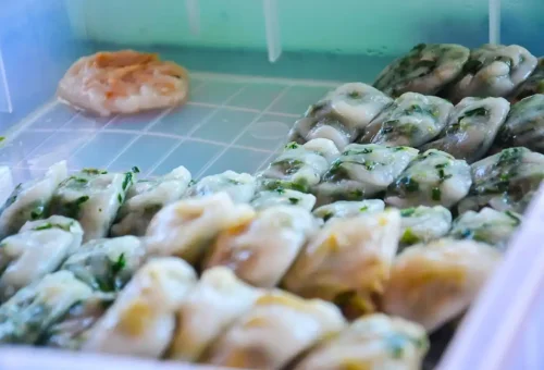 Traditional Thai garlic chive dumplings freshly prepared at a local Thonburi food stall