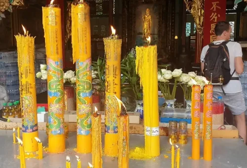 Burning dragon-engraved candles at a Bangkok Chinese temple
