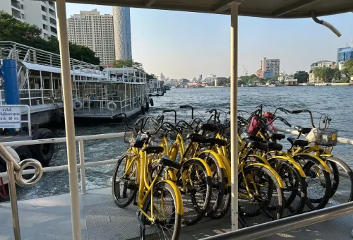 Yellow bicycles on a ferry crossing the Chao Phraya River