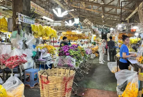 Colorful flower market with shoppers and vibrant blooms