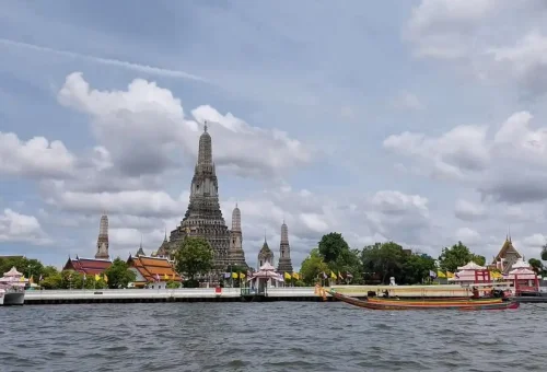 Tour guide and guest unloading bright yellow bicycles onto a canal boat.