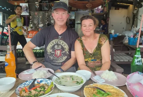 Couple enjoying authentic Thai lunch at a local restaurant during the tour.