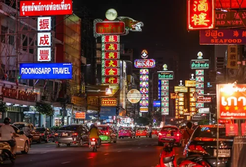Vibrant night view of Yaowarat Road with neon signs and traffic