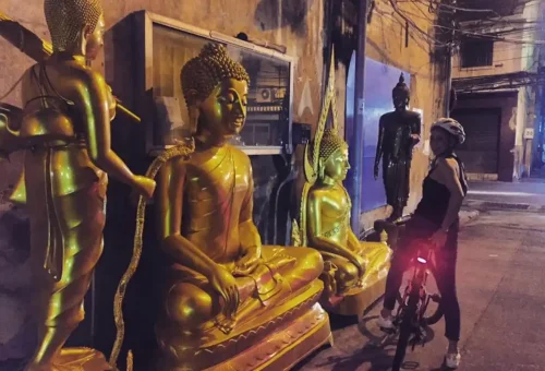 A quiet moment with golden Buddha statues in an unexpected alley corner.