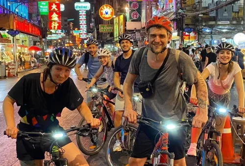 Night riders cruising through Yaowarat Road, Chinatown — alive with neon lights and street energy.