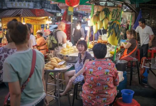 Colorful mango sticky rice stall in Bangkok’s Chinatown at night