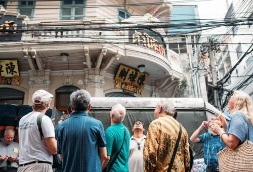 Tour group exploring heritage buildings in Bangkok Chinatown