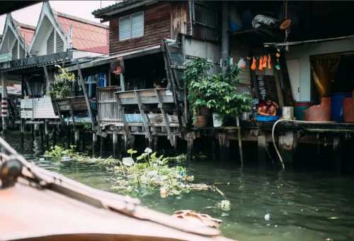 Bangkok canal stilt houses seen from a longtail boat