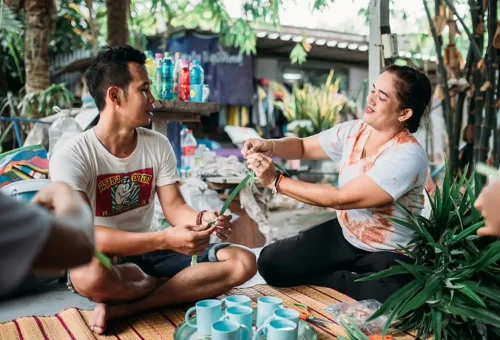 Locals teaching handicraft weaving with pandan leaves
