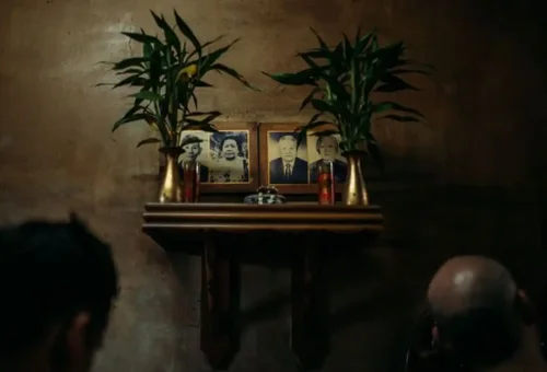 Ancestral altar with black and white portraits in a wooden home