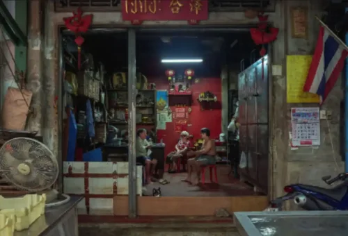 Thai family sitting in a traditional Chinese shophouse