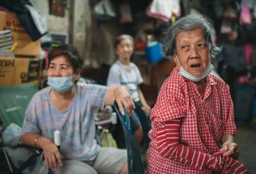 Elderly women sitting in a Bangkok shophouse community