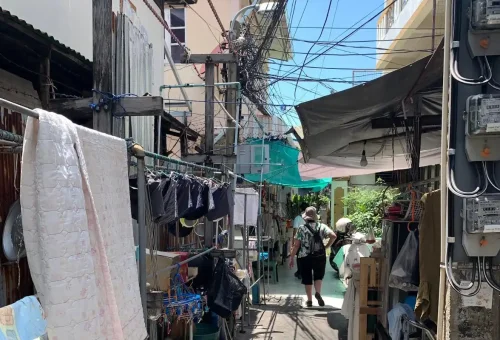 Tourists walking through narrow residential alley in Chinatown