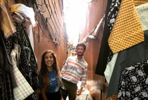 Tourists exploring a narrow clothing alley in Chinatown Bangkok
