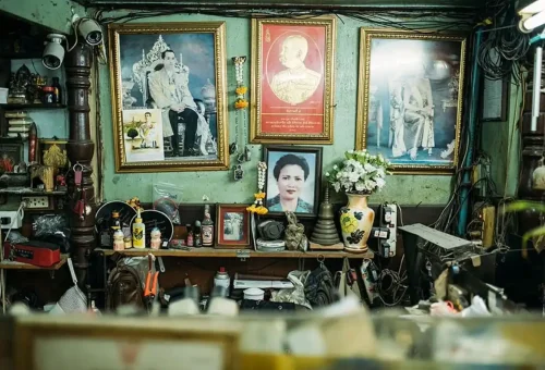 Vintage Thai interior with royal portraits and traditional items