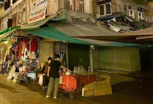 Street vendors selling clothes and snacks at night in Chinatown