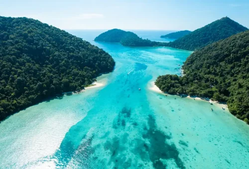 Aerial view of Surin Islands’ turquoise channel and lush green islands