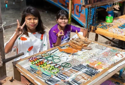 Local Moken woman weaving a fishing net in her wooden home