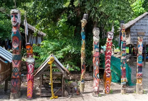 Painted wooden spirit poles (totems) used by the Moken people in traditional rituals on Surin Islands.