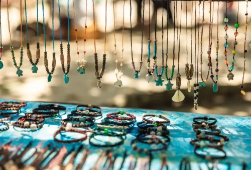 Display of handmade bracelets, necklaces, and seashell jewelry by the Moken people at Surin Islands market.