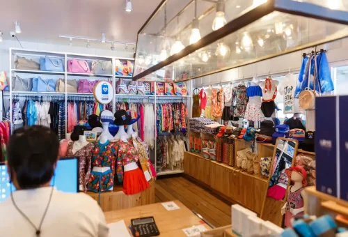 Colorful beachwear, hats, and bags displayed in a gift shop near Similan Islands pier.