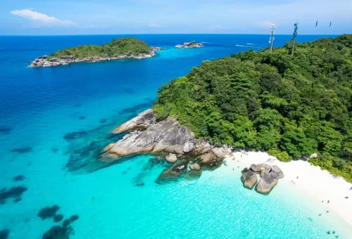 Crystal-clear blue waters and rocky coastline of the Similan Islands