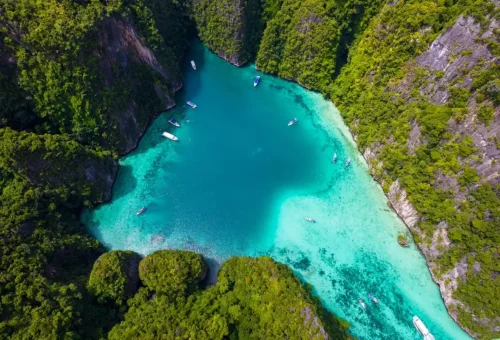 Aerial view of boats floating in emerald Pileh Lagoon, Phi Phi