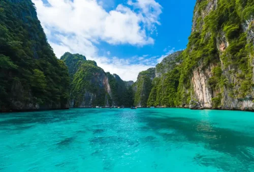 Scenic view of turquoise lagoon surrounded by limestone cliffs in Phi Phi