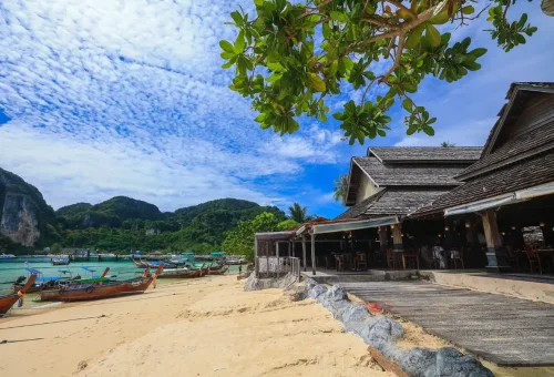 Traditional Thai longtail boats anchored on the shore of Phi Phi Island.