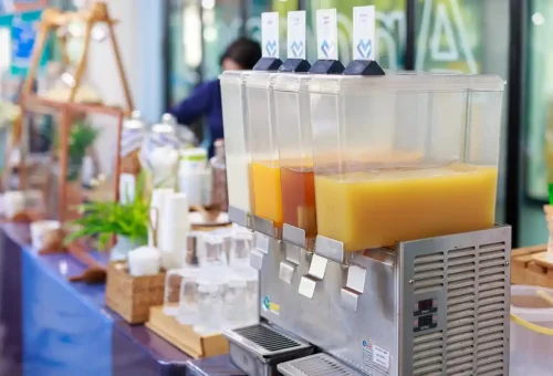 Juice dispensers at the Phuket Travel Store pier lounge before tour.