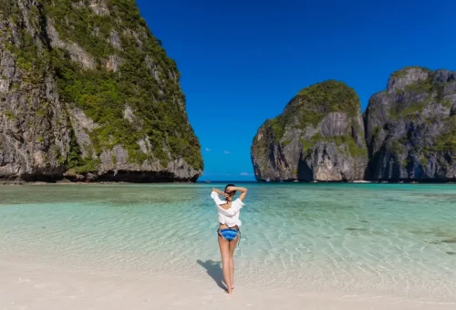 Woman enjoying the turquoise waves on Maya Bay beach.