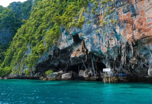 Viking Cave on Phi Phi Leh with wooden ladders and blue water.