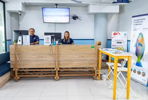 Friendly tour staff welcoming guests at Phuket Travel Store counter