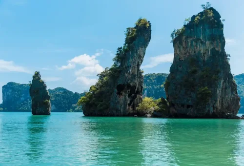 Unique rock formations rising from emerald water near Hong Island