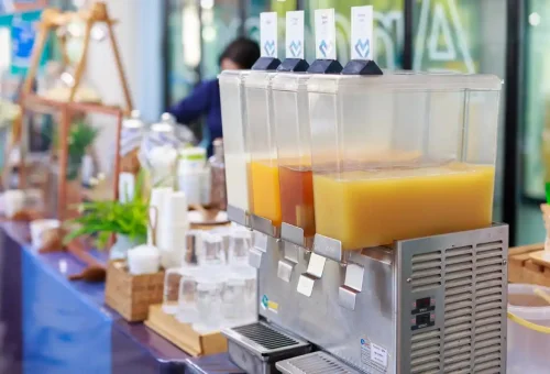 Juice dispensers at welcome refreshment counter before boat trip