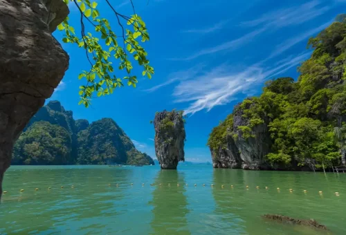 View of James Bond Island framed by a rock and tree branch
