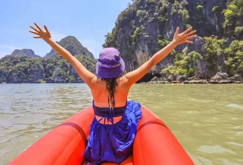 Woman kayaking through sea caves near Hong Island