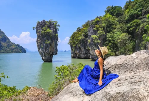 Woman posing on viewpoint with James Bond Island in the background