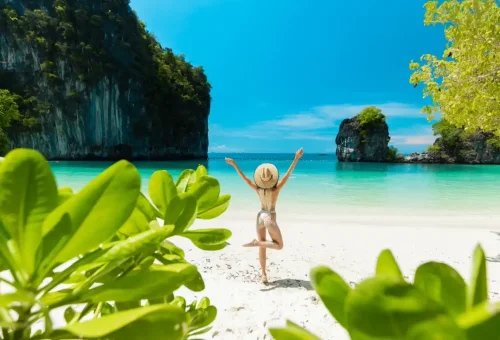 Woman standing on tropical beach at Hong Island
