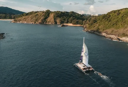 Aerial view of luxury catamaran Ombre Yacht sailing along the Phuket coast.