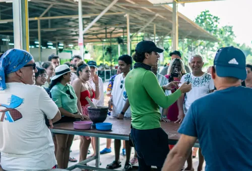 Tour guide explaining elephant behavior to a group of visitors