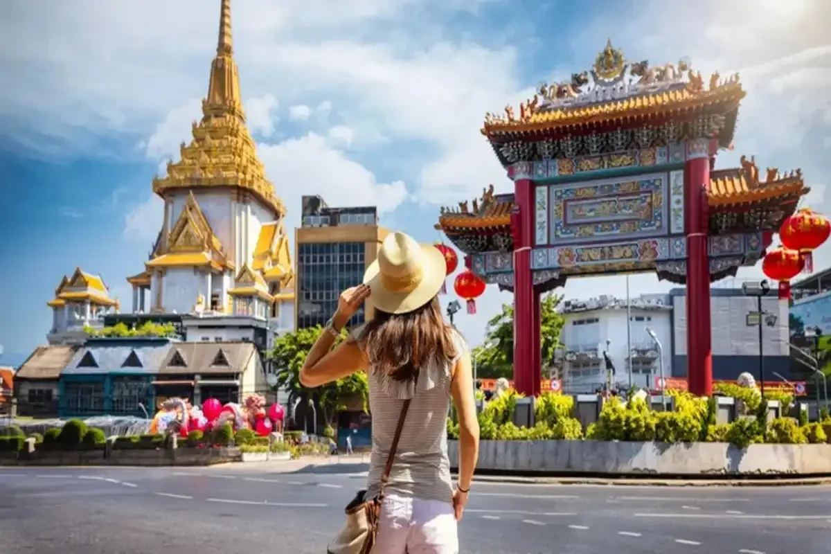 Tourist admiring Chinatown Gate and Golden Temple in Bangkok, Thailand