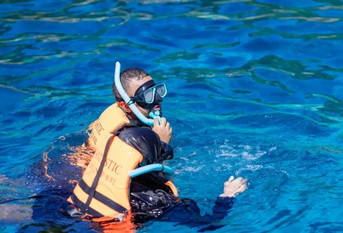 Snorkeler with mask and life vest exploring Similan Islands Phuket.