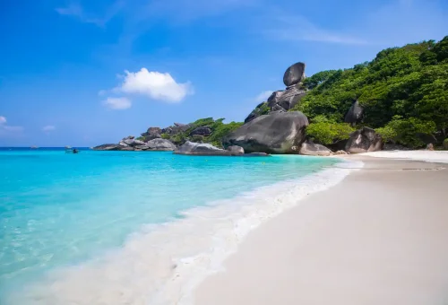 Iconic Donald Duck Rock at Similan Islands with soft white sand beach and turquoise waves near Phuket.