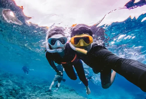 Couple snorkeling together in turquoise water at Similan Islands Phuket.