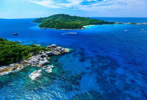 Aerial view of Similan Islands with lush greenery, coral reefs, and turquoise waters.